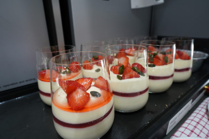 a group of glasses with desserts on it