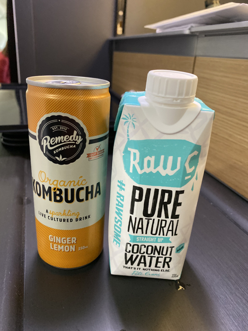 a beverage carton and a can of kombucha