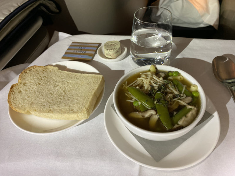 a bowl of soup and bread on a table