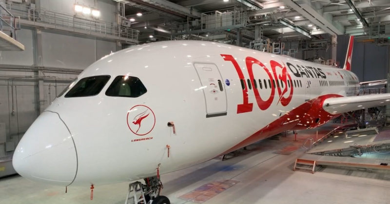 a white and red airplane in a hangar
