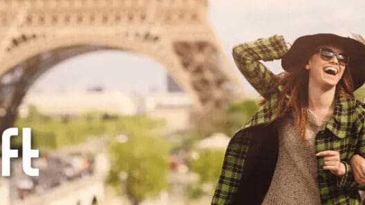 a woman in a sweater and a scarf in front of a tower