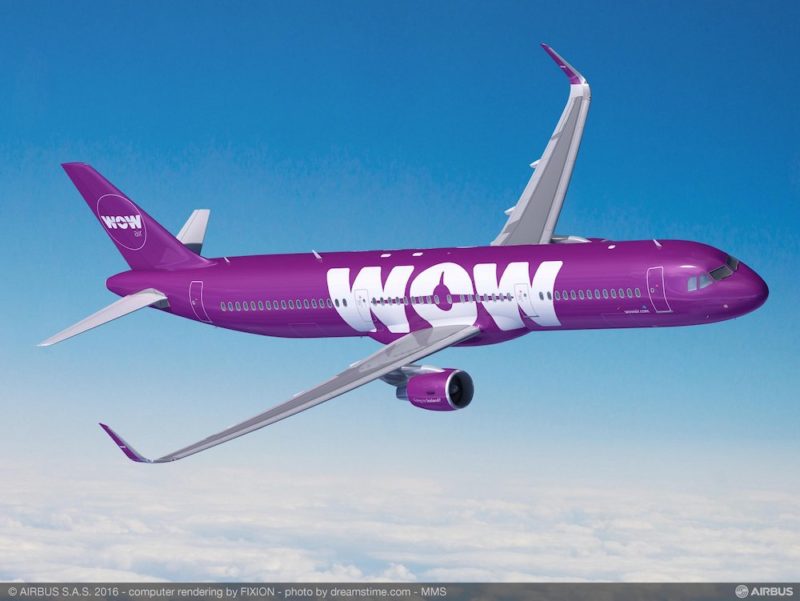 a purple airplane flying in the sky