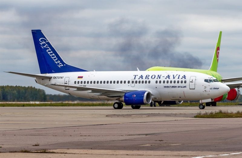 a white and blue airplane on a runway