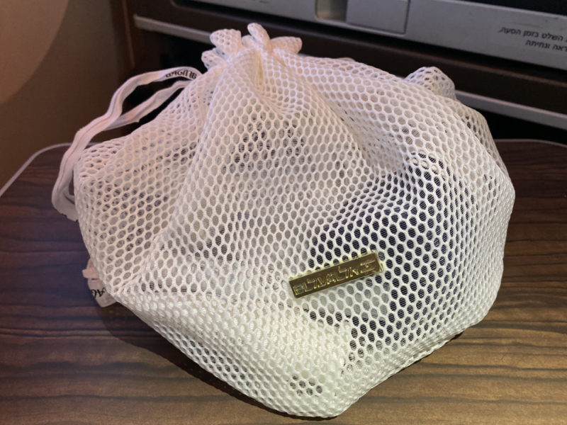 a white mesh bag with a tag on it