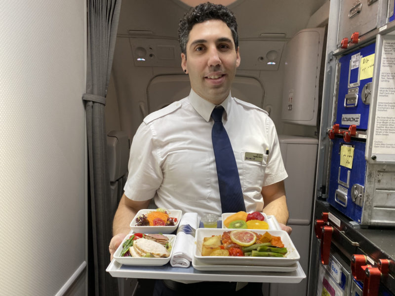 a man holding a tray of food