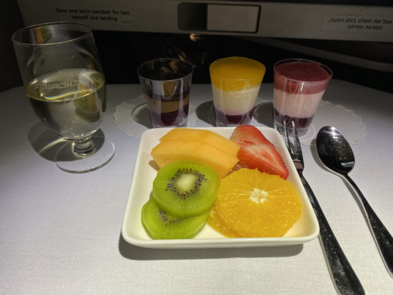 a plate of fruit and yogurt cups