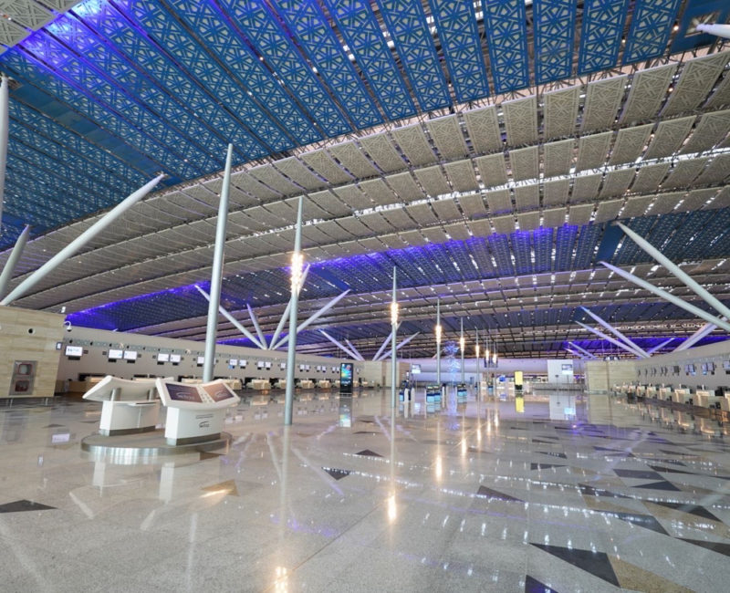 a large airport with a blue ceiling