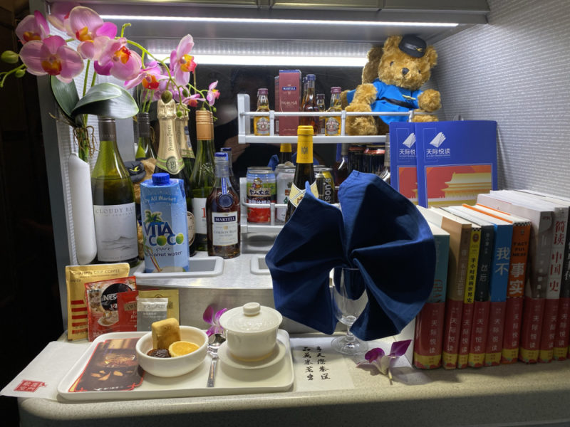 a shelf with a variety of alcohol and books