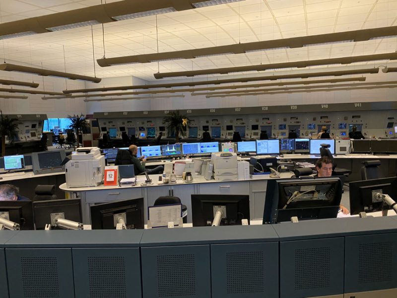 a room with many computers and people sitting at desks