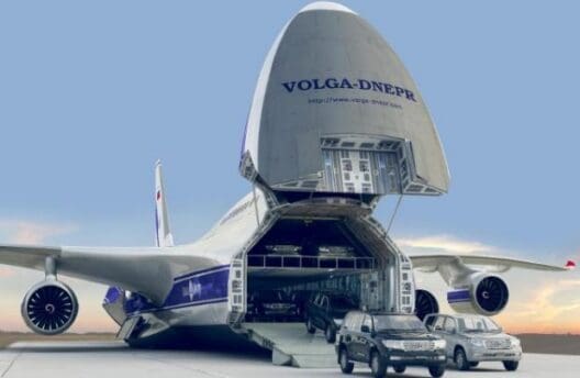 a plane with cars parked next to it