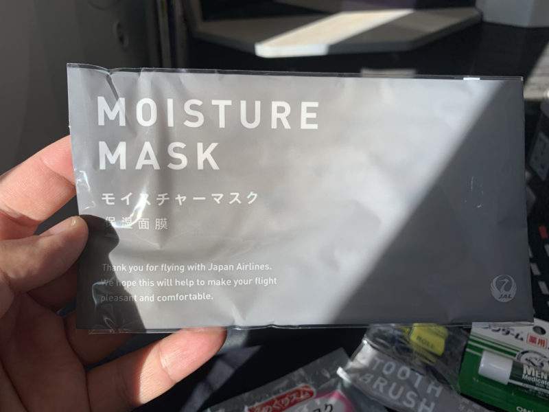 a hand holding a package of moisture mask