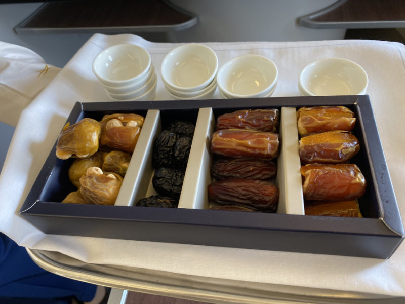 a tray of dried fruits and cups