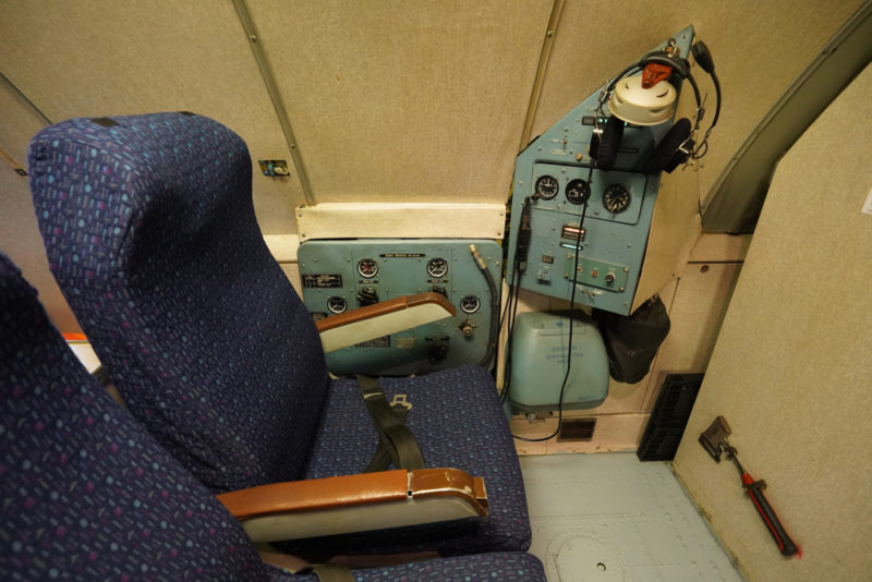 a seat in a room with control panel and buttons