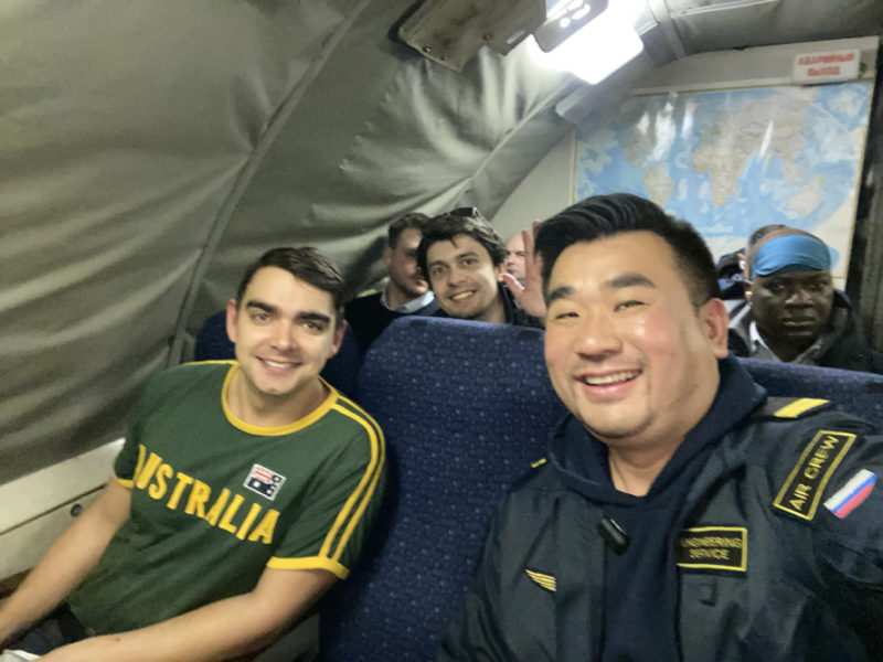 a group of men sitting in a plane