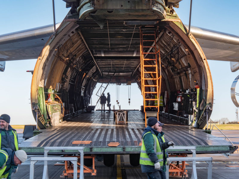 a man standing next to a plane