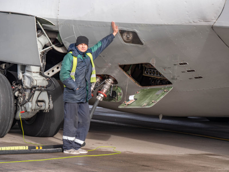 a man standing next to a jet