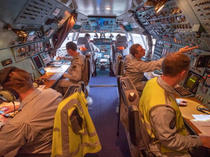 a group of men in a cockpit