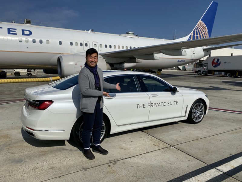 a man standing next to a car