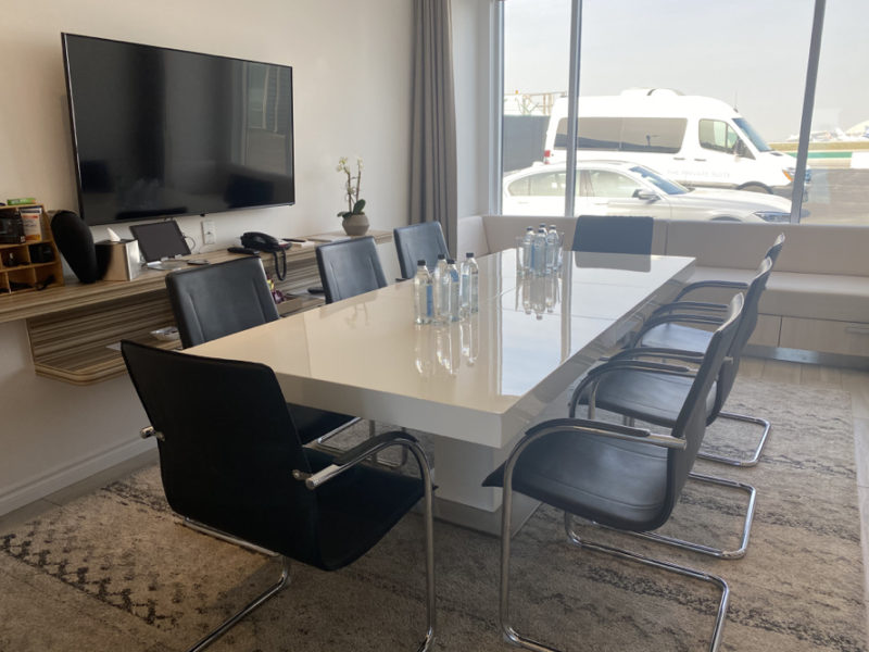 a table with chairs and a television in a room