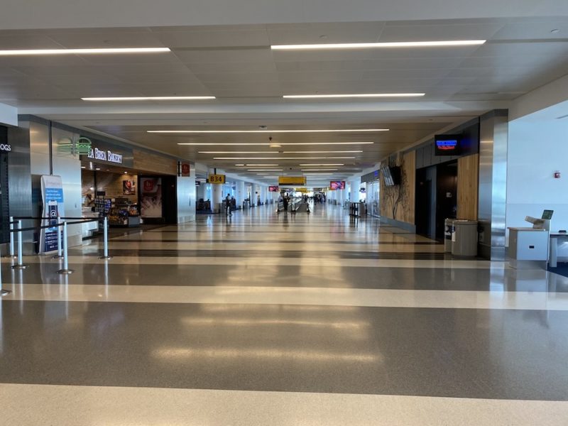 a large airport terminal with people walking