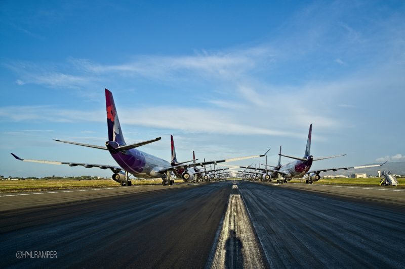 a row of airplanes on a runway