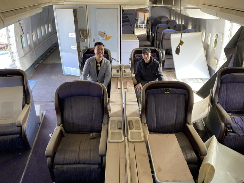 two men sitting in an airplane