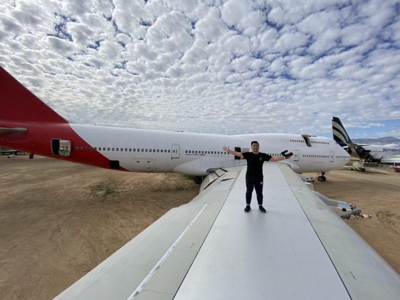 a man standing on the wing of an airplane