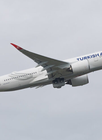 a white airplane in the sky