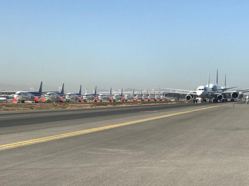 a group of airplanes on a runway