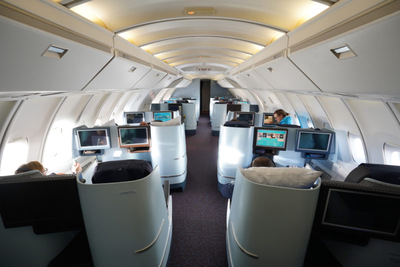 people sitting in a plane with computers