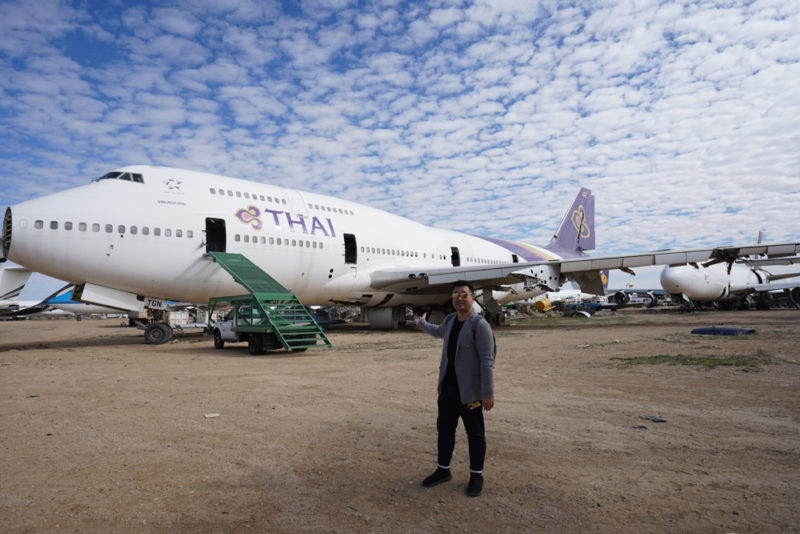 a man standing in front of an airplane