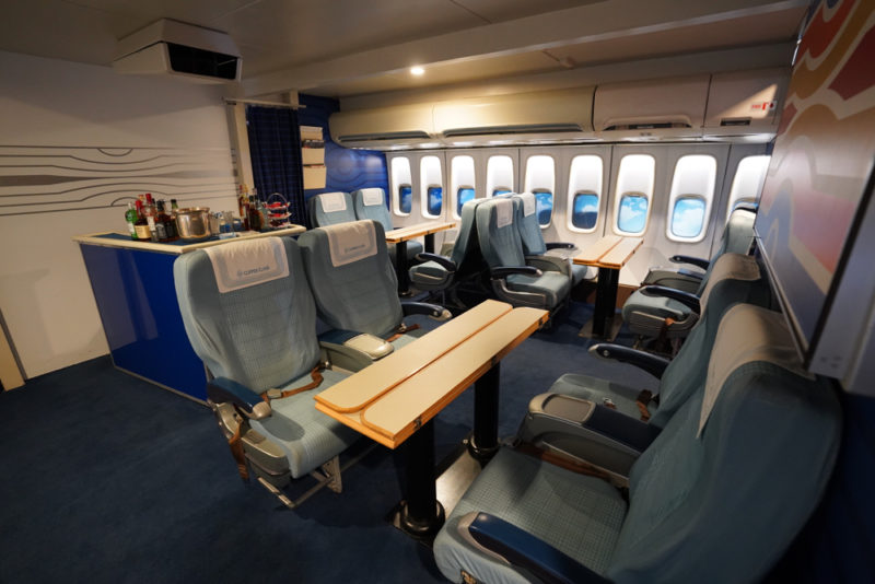 a plane with blue seats and tables