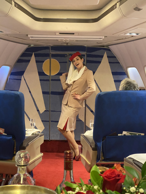 a woman in a uniform in a plane