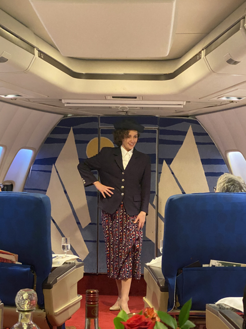 a woman standing in a plane