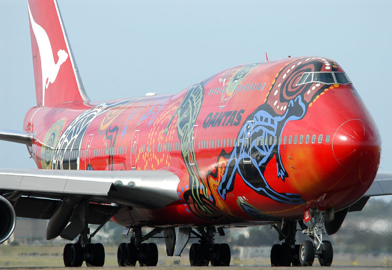 a red airplane with a painted design on it