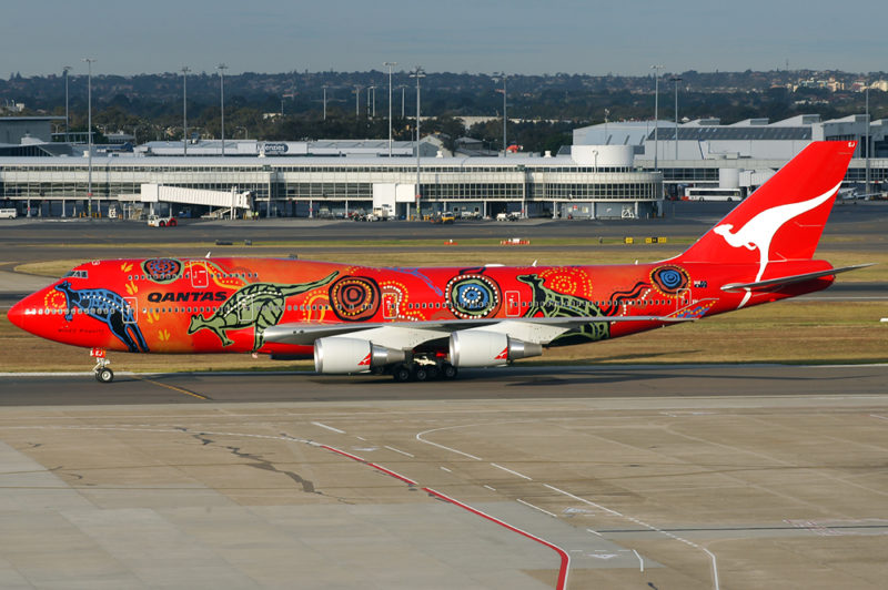 a red airplane with colorful designs on it