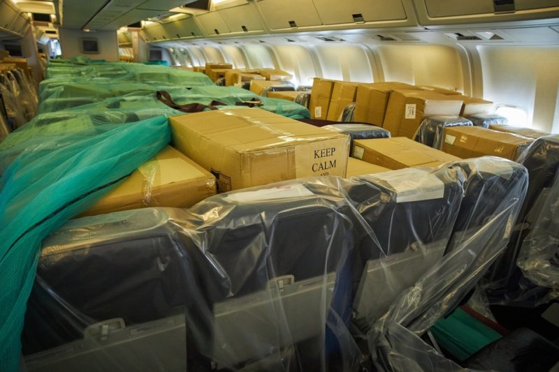 a plane with many boxes wrapped in plastic