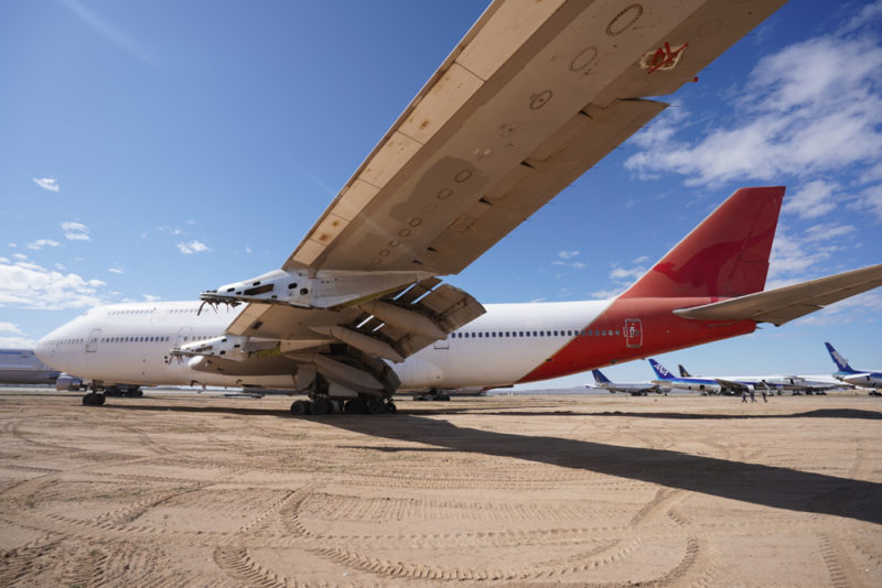 a large airplane on a dirt field