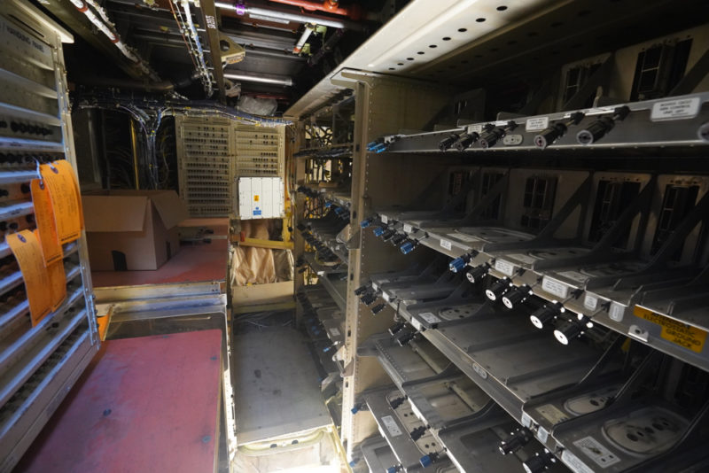 a room with many shelves and wires