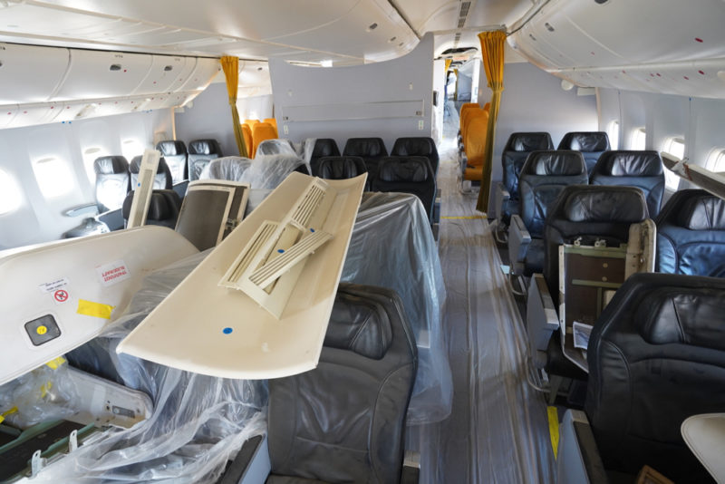 inside an airplane with seats covered in plastic