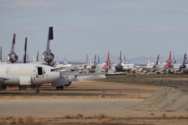 a group of airplanes on a runway