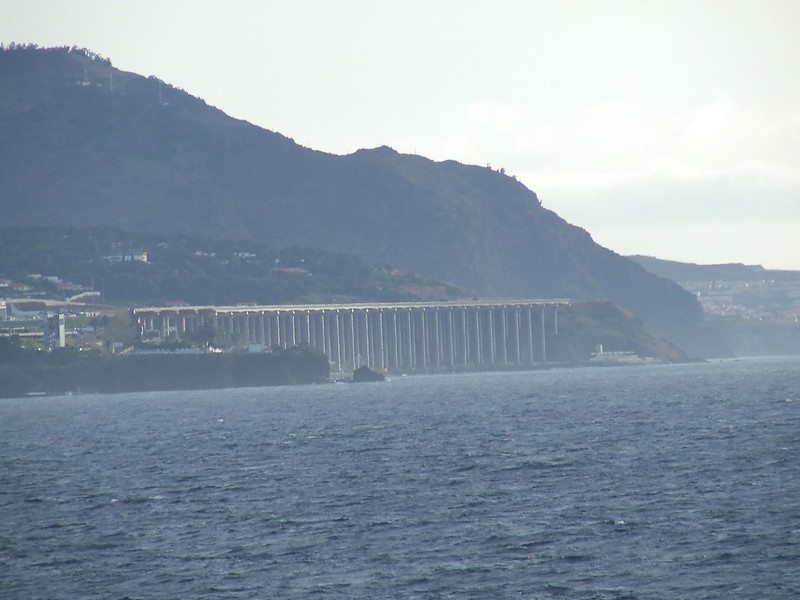 a large body of water with a bridge over it