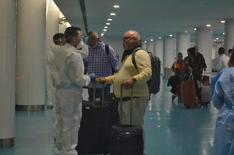 a group of people in protective gear standing in a hallway