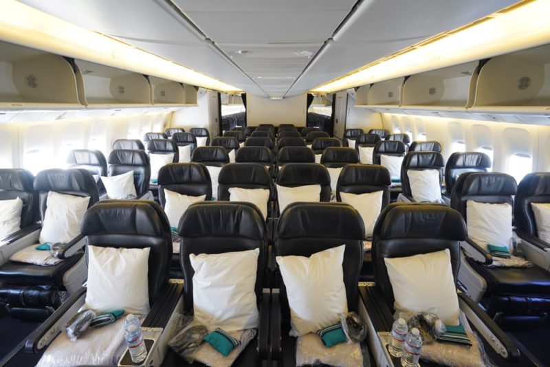 a plane with black seats and white pillows
