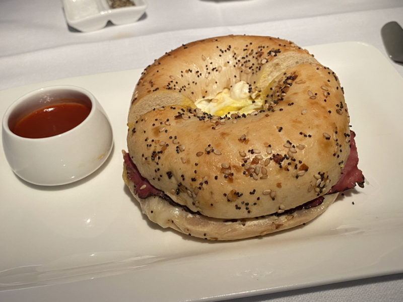 a bagel sandwich with a sauce on a plate