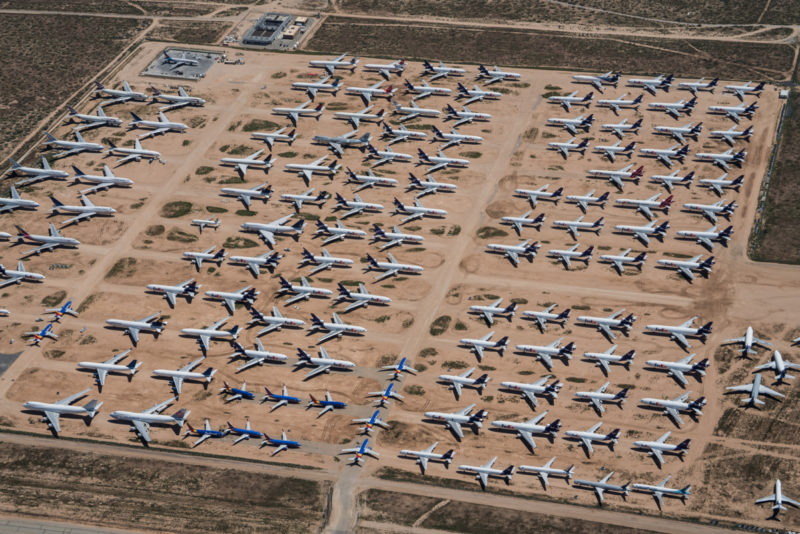 an aerial view of airplanes in a field