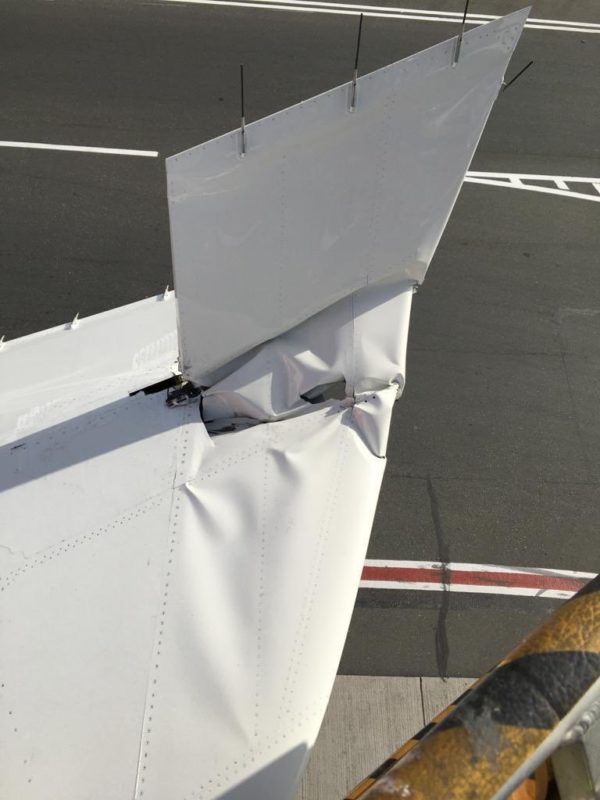 a white plane wing with a broken wing