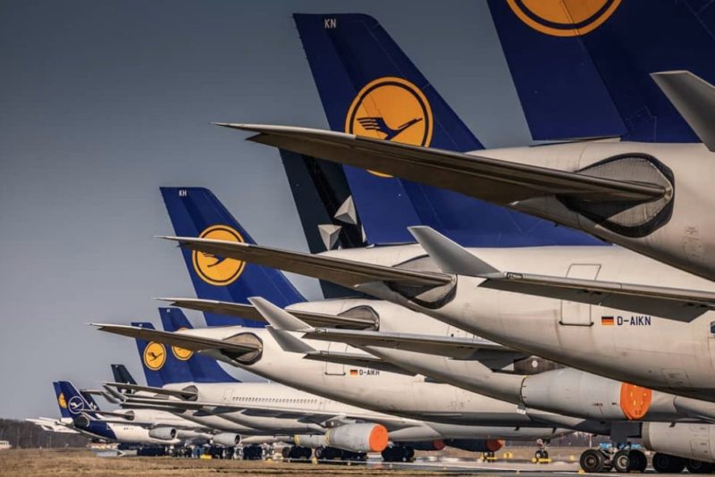 a row of airplanes parked on a runway