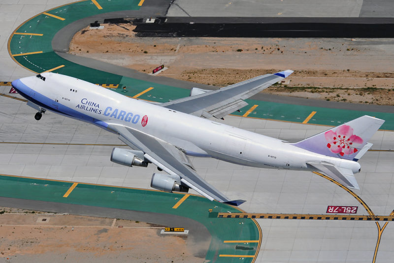 a plane flying over a runway