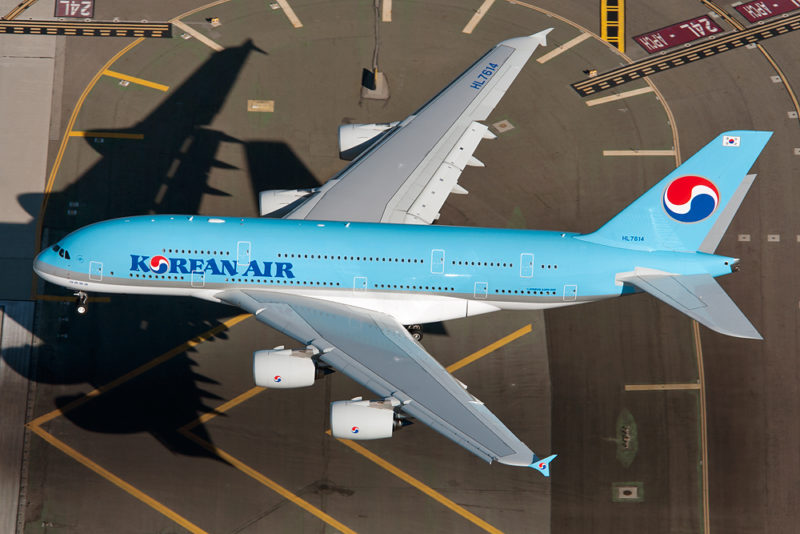 a blue airplane on a runway